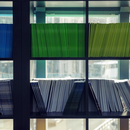 Library shelves containing dozens of published journals.